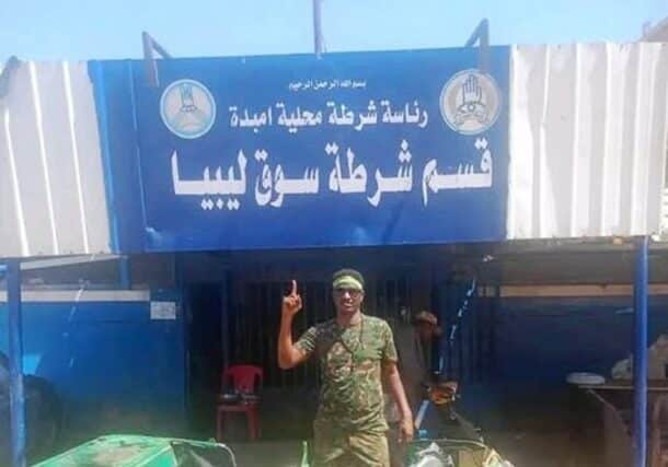 Sudanese soldier poses outside the Libya Market police station on March 29, 2025