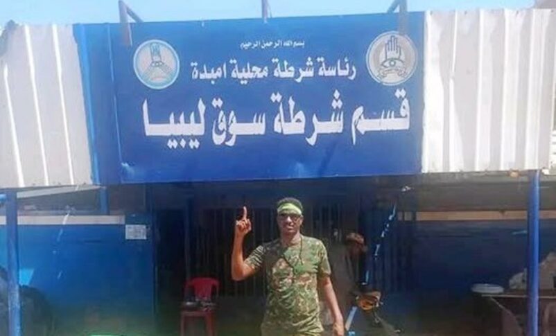 Sudanese soldier poses outside the Libya Market police station on March 29, 2025
