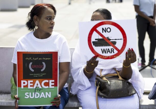 Demonstrators hold signs during a rally, on the opening day of international meeting for peace in Sudan, in Geneva, August 14, 2024 AP photo.