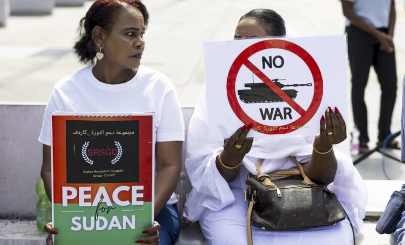 Demonstrators hold signs during a rally, on the opening day of international meeting for peace in Sudan, in Geneva, August 14, 2024 AP photo.