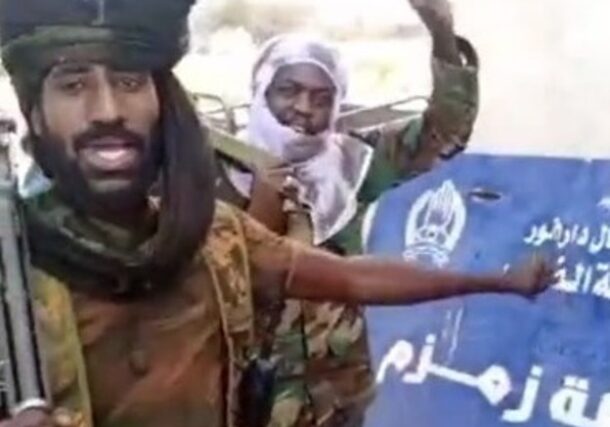 RSF fighters point to the police station sign at Zamzam camp after taking control of the area, North Darfur, April 13, 2025.