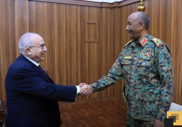 Sudan's Burhan shakes hands with UN special envoy Lamamra on April 23, 2025