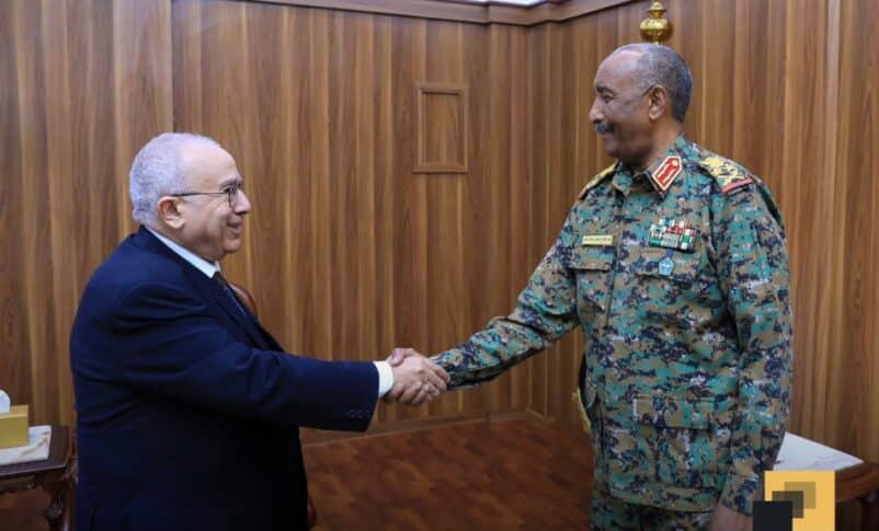 Sudan's Burhan shakes hands with UN special envoy Lamamra on April 23, 2025