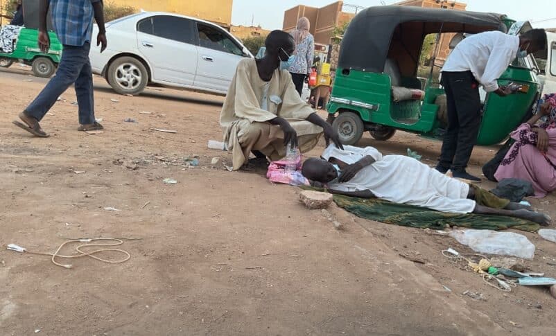 A cholera patient lies on the ground outside Al-Nao Hospital in Omdurman. (Photo Sudan Tribune) 950
