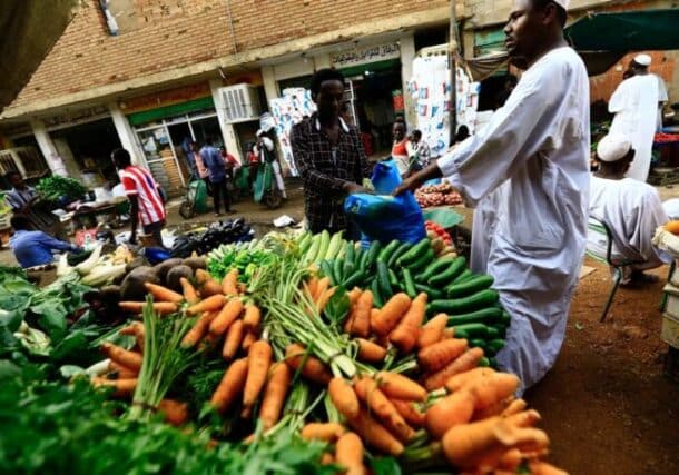 A man waits to buy food at a market in Khartoum , Reuters file photo