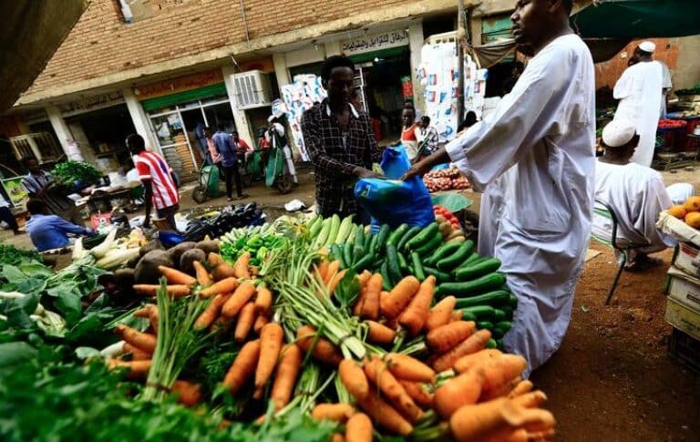 A man waits to buy food at a market in Khartoum , Reuters file photo