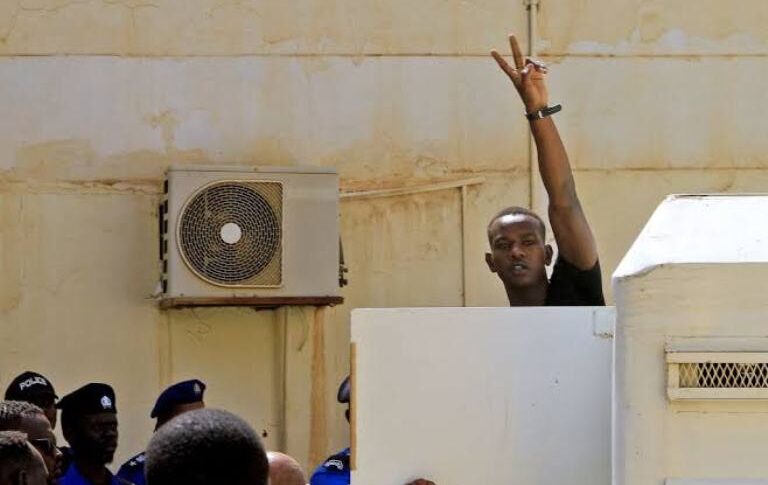 Mohamed Adam Tupac get out of a car to attend his trial at a court in Khartoum, file photo