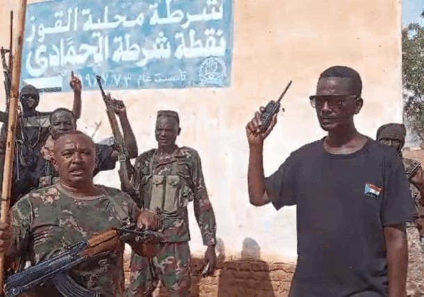 Sudanese army forces stand outside the Al-Hamadi police station, marking their recapture of the South Kordofan town on May 13, 2025