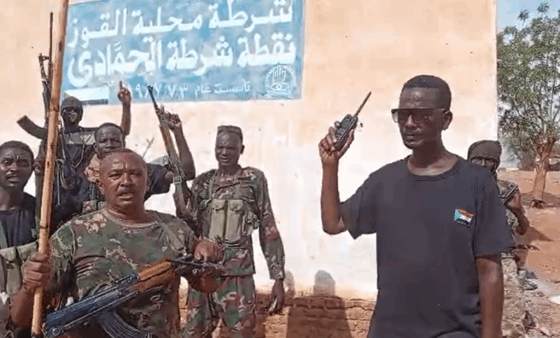 Sudanese army forces stand outside the Al-Hamadi police station, marking their recapture of the South Kordofan town on May 13, 2025