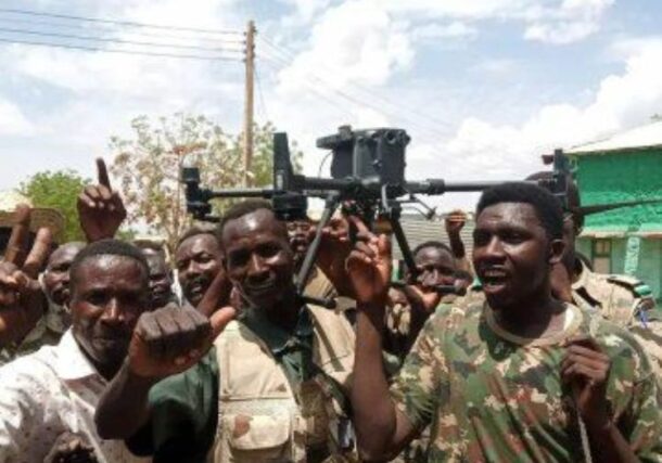 Sudanese soldiers hold a drone captured in Dilling on June 25, 2025