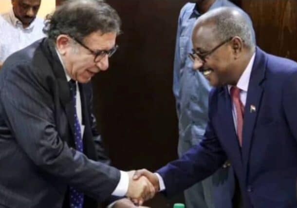 Abdullah Diraf, Sudan's Minister of Justice, greets Radhouane Nouicer, the U.N. Independent Expert, ahead of their meeting in Port Sudan on July 28, 2025.