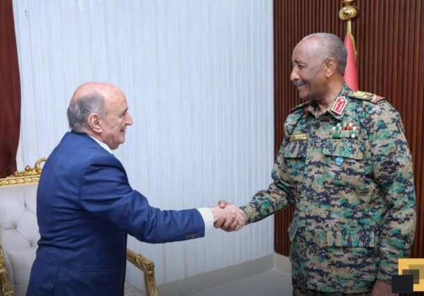 General Abdel Fattah al-Burhan, head of Sudan's Sovereignty Council, greets African Union envoy Mohamed Belaiche in Port Sudan on July 29, 2025.