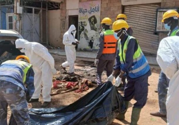 Members of a forensic team handle a body bag in Khartoum, in this file photo.