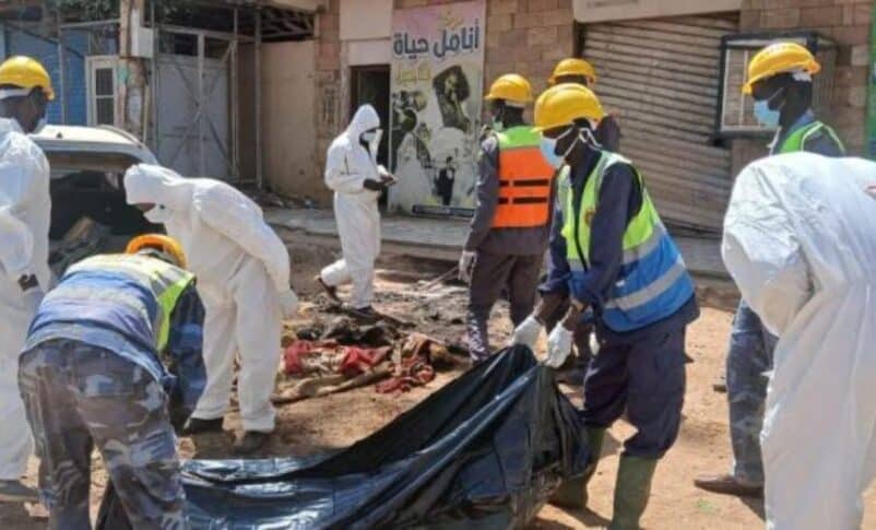 Members of a forensic team handle a body bag in Khartoum, in this file photo.