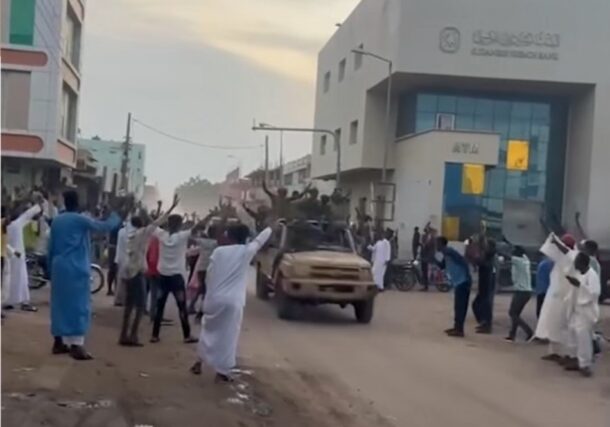 Civilians cheer members of the Sudanese army and allied forces in El-Obeid of North Kordofan, following clashes with the RSF paramilitary, August 21, 2025.