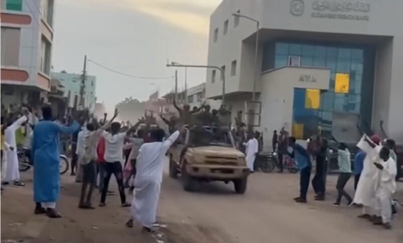 Civilians cheer members of the Sudanese army and allied forces in El-Obeid of North Kordofan, following clashes with the RSF paramilitary, August 21, 2025.