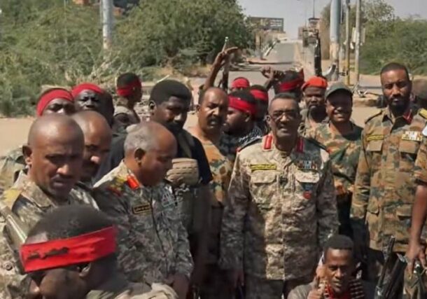 Major General Nasr al-Din Abdel Fattah (C) poses with officers and soldiers at the Armored Corps base in Khartoum, Sudan, in this undated handout photo.