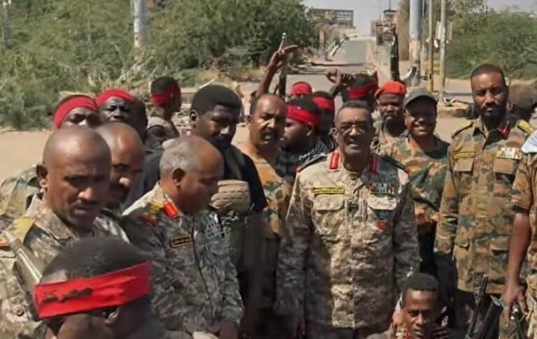 Major General Nasr al-Din Abdel Fattah (C) poses with officers and soldiers at the Armored Corps base in Khartoum, Sudan, in this undated handout photo.