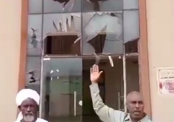 An official from the RSF-run administration points at a damaged building following what local authorities described as a Sudanese army airstrike in El Daein, August 13, 2025.