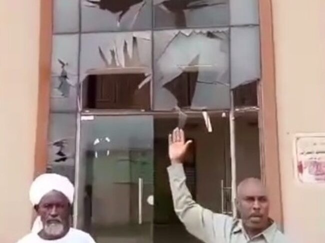 An official from the RSF-run administration points at a damaged building following what local authorities described as a Sudanese army airstrike in El Daein, August 13, 2025.