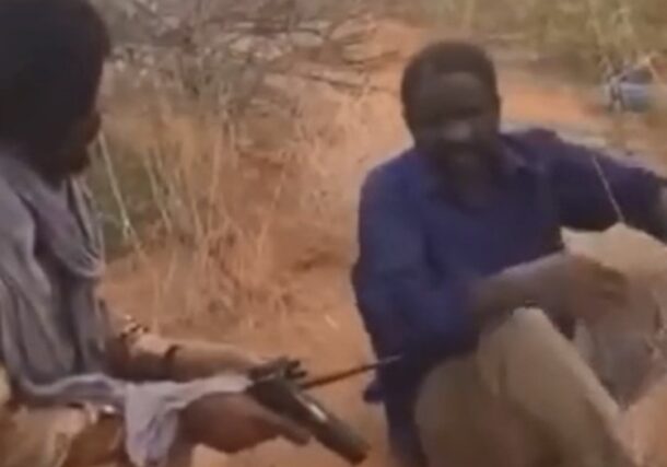 An RSF officer questions a civilian in El Fasher, in this image from a video circulated online by RSF members, August 17, 2025. The civilian was executed moments later.