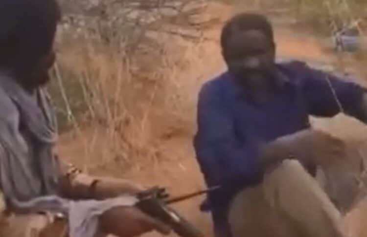 An RSF officer questions a civilian in El Fasher, in this image from a video circulated online by RSF members, August 17, 2025. The civilian was executed moments later.