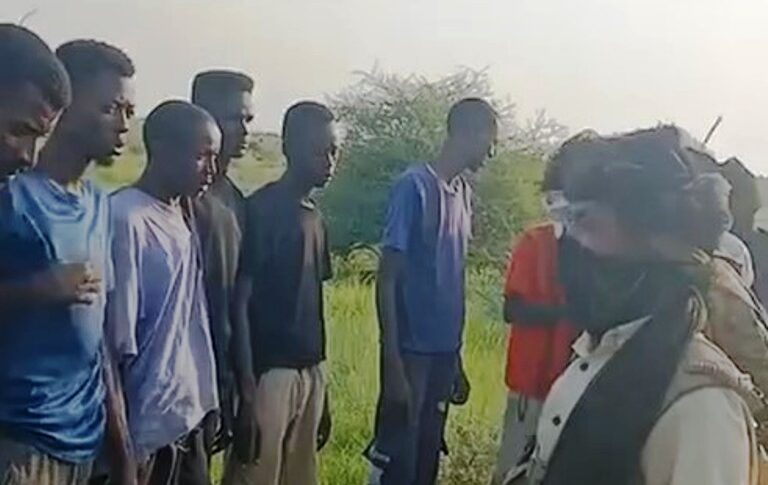 Civilians are detained by RSF fighters as they try to escape the besieged city of El Fasher on August 20, 2025.