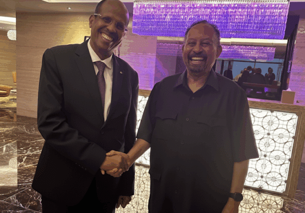 Abdalla Hamdok (R), Sudan's former PM and Somoud leader, shakes hands with Mahmoud Ali Youssouf, Chairperson of the AU Commission, in Abu Dhabi, Sept 12, 2025.