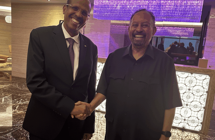 Abdalla Hamdok (R), Sudan's former PM and Somoud leader, shakes hands with Mahmoud Ali Youssouf, Chairperson of the AU Commission, in Abu Dhabi, Sept 12, 2025.