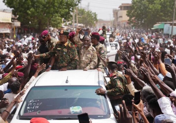 Sudan's army chief, Abdel Fattah al-Burhan, gestures to civilians during a visit to El-Obeid, North Kordofan state, Sudan, September 27, 2025.