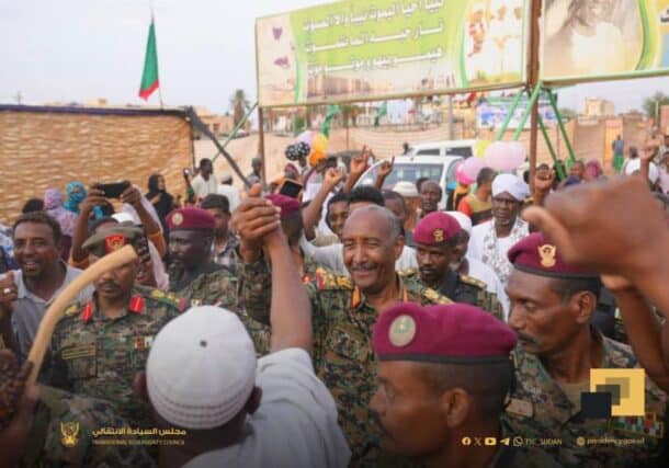Sudan's army chief, General Abdel Fattah al-Burhan, greets a civilian during celebrations for the Prophet Mohammad's birthday in Omdurman, Sudan, August 28, 2025