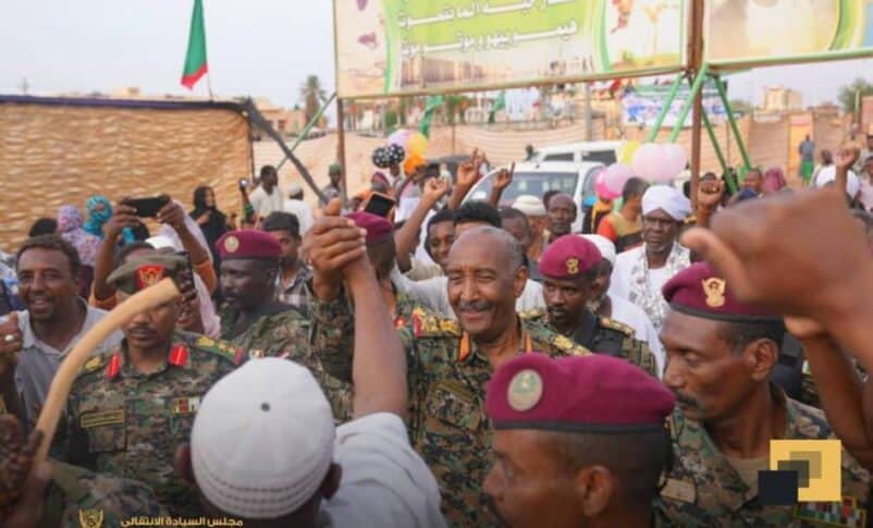 Sudan's army chief, General Abdel Fattah al-Burhan, greets a civilian during celebrations for the Prophet Mohammad's birthday in Omdurman, Sudan, August 28, 2025