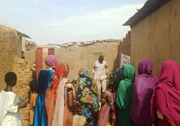 Residents assist an individual weakened by starvation at the Abu Shouk camp in El Fasher on Aug. 26, 2025