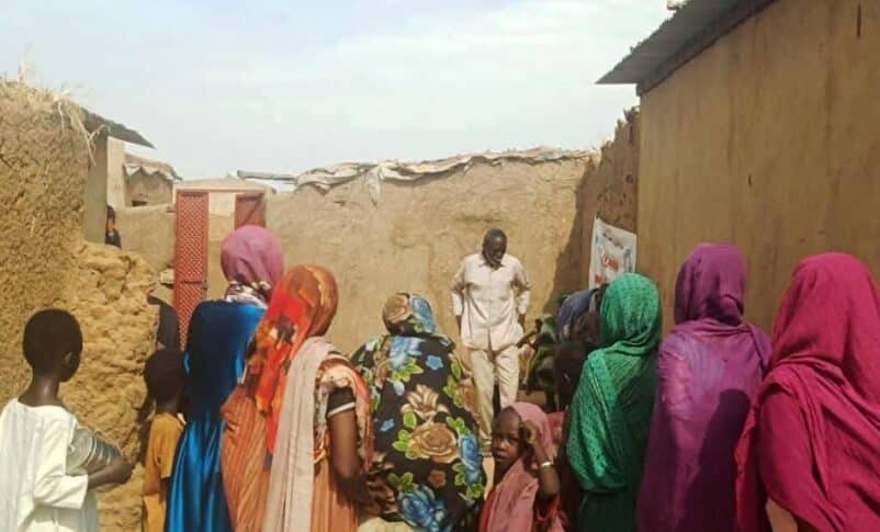 Residents assist an individual weakened by starvation at the Abu Shouk camp in El Fasher on Aug. 26, 2025