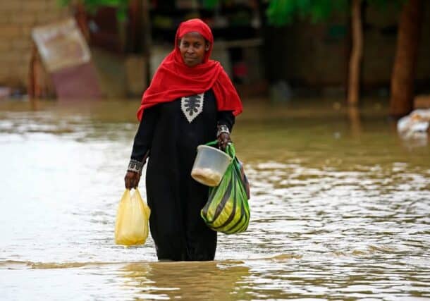 A Sudanese woman wades through a street flooded with rainwater in Khartoum, Sudan, September 24, 2025.