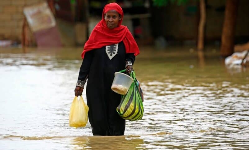 A Sudanese woman wades through a street flooded with rainwater in Khartoum, Sudan, September 24, 2025.