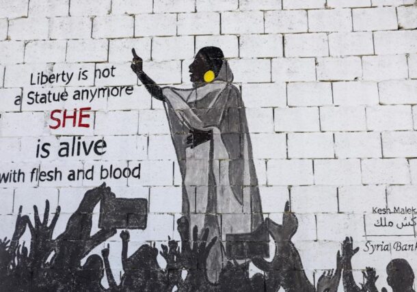 A mural shows protester Alaa Salah leading chants against President Omar al-Bashir AFP photo