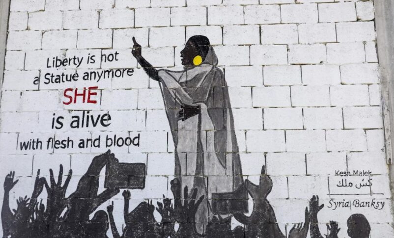 A mural shows protester Alaa Salah leading chants against President Omar al-Bashir AFP photo