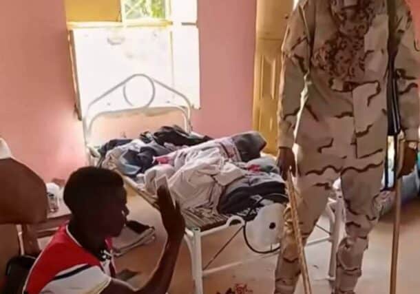 An RSF fighter questions and beats a Sudanese Red Crescent member with a stick in a video released on Oct. 28, 2025