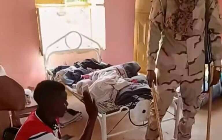 An RSF fighter questions and beats a Sudanese Red Crescent member with a stick in a video released on Oct. 28, 2025