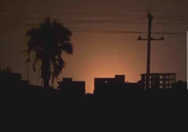 An explosion illuminates the sky near Khartoum's airport at dawn on Tuesday, Oct 21, 2025