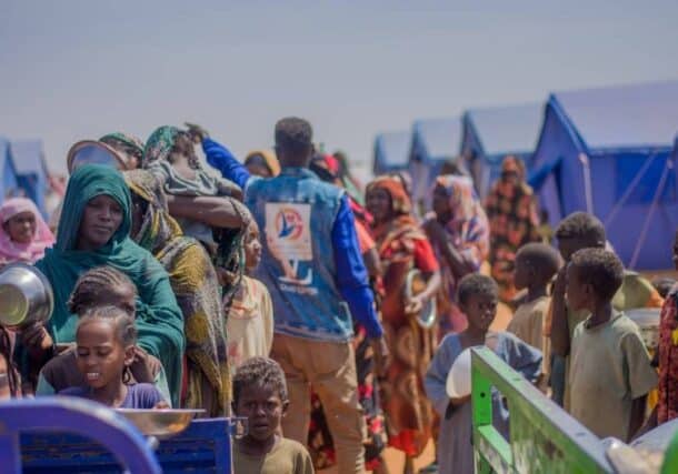 Displaced people from Bara queue to receive a meal at a displacement camp in El Obeid, North Kordofan, on October 23, 2025.