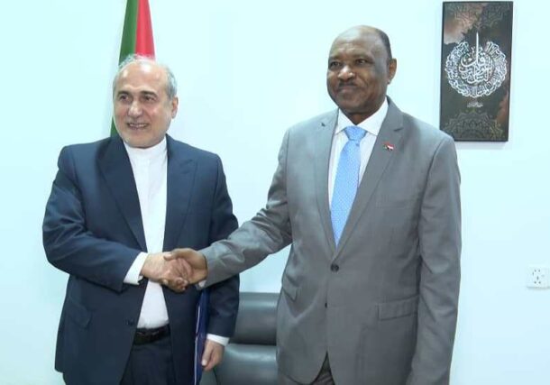 Sudan's FM shakes hands withthe Iranian ambassador in Port Sudan on Nov 9, 2025