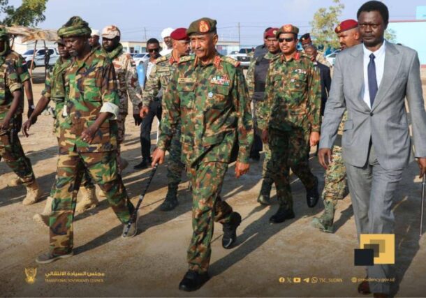 Al-Burhan (C) arrives for a memorial for SLA fighters in Port Sudan flaked by Minnawi (R) and his deputy commander on Dec 1, 2025