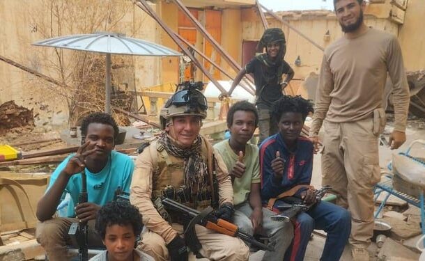 Colombian mercenaries pose with young fighters from the Rapid Support Forces (RSF) in Darfur, Sudan, in this undated photo obtained from social media.