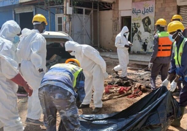 Health workers recover bodies in the streets of the East Nile locality, file photo