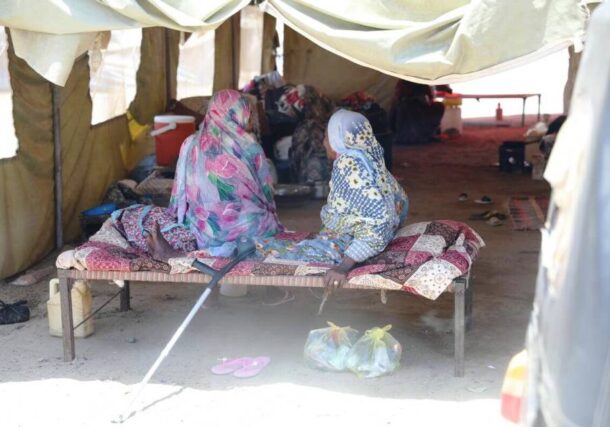 Two women sit together at an IDP camp in Port Sudan. UNFPA Sudan photo