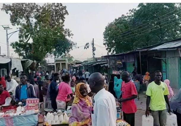 People walk through a market in Dilling, South Kordofan, Sudan, December 13, 2025.