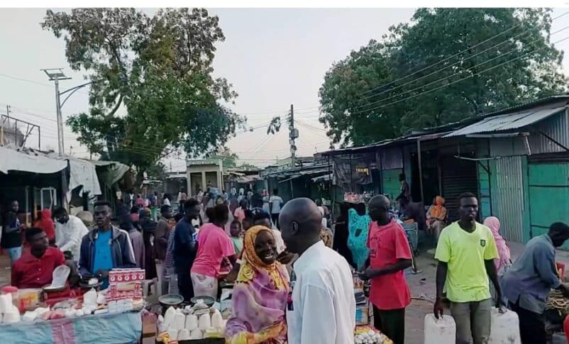 People walk through a market in Dilling, South Kordofan, Sudan, December 13, 2025.