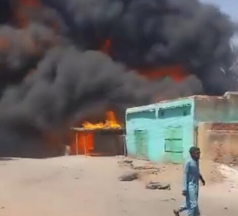 A large plume of smoke rises over the city of Ed Daein in Darfur on March 8, 2026, after an army drone strike targeted a fuel market.